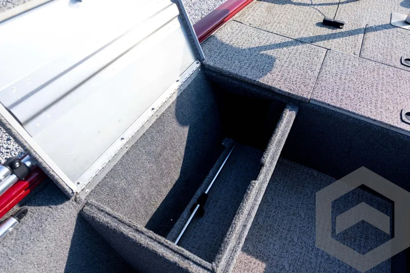Slide: The Image of 2022 Tracker Pro 170 boat storage compartment with open lid, showcasing interior space. - 44
