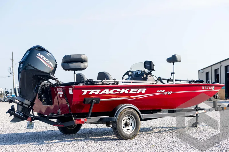 Slide: The Image of 2022 Tracker Pro 170 boat with Mercury engine, parked on gravel. - 5