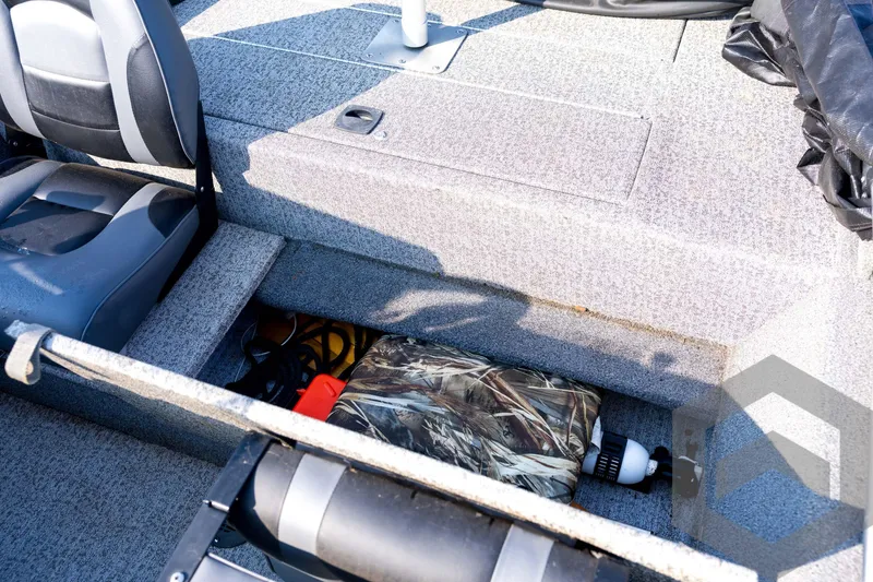 Slide: The Image of 2022 Tracker Pro 170 boat interior with storage compartment and seating. - 52