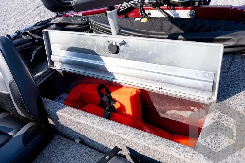 Slide: The Image of Open storage compartment in 2022 Tracker Pro 170 boat with life jackets inside. - 53