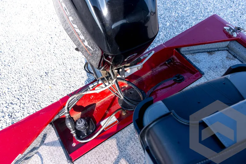 Slide: The Image of 2022 Tracker Pro 170 boat engine and seating area, featuring red and black design. - 56