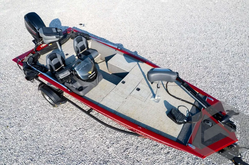 Slide: The Image of 2022 Tracker Pro 170 boat on gravel, featuring dual seats and a motor. - 64