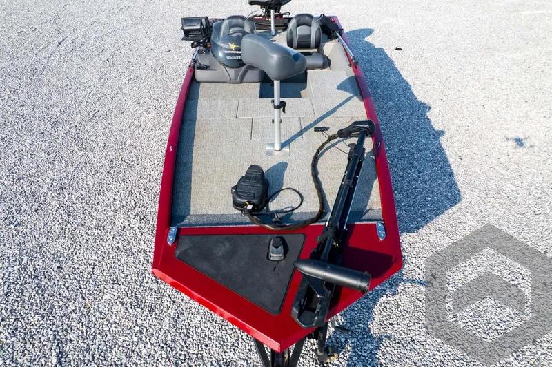 Slide: The Image of 2022 Tracker Pro 170 boat with red exterior and fishing equipment on gravel surface. - 68