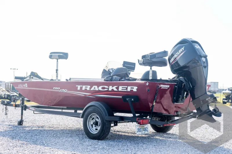 Slide: The Image of 2022 Tracker Pro 170 boat with Mercury engine on a trailer, parked on gravel. - 7