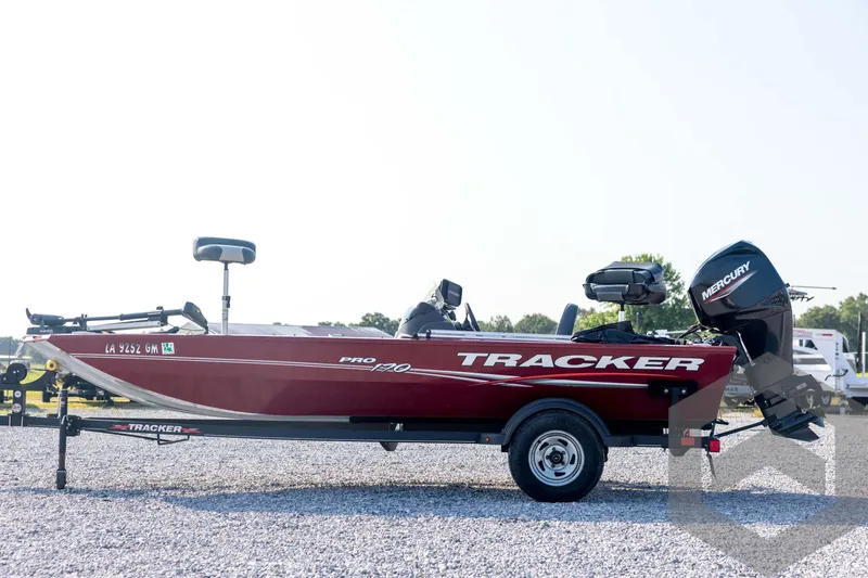 Slide: The Image of 2022 Tracker Pro 170 boat with Mercury engine on trailer, parked on gravel. - 8