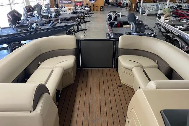 Slide: The Image of 2025 Bentley Pontoons Legacy 223 Swingback interior with beige seating and wood-style flooring. - 4