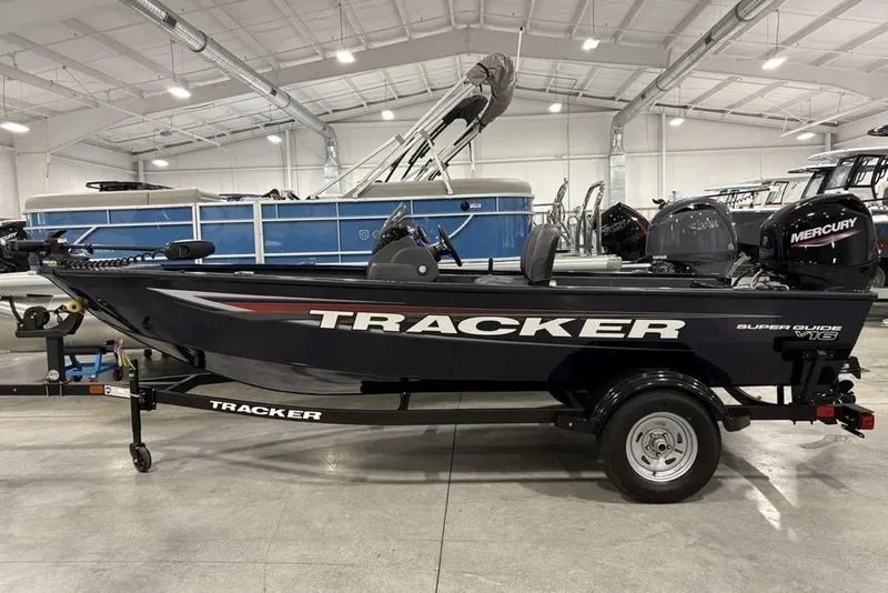 The Image of 2026 Tracker Super Guide™ V-16 SC boat in showroom, side view with Mercury engine. - 1