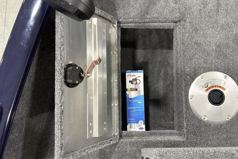 Slide: The Image of 2026 Tracker Super Guide™ V-16 SC boat interior with storage compartment and safety equipment. - 10