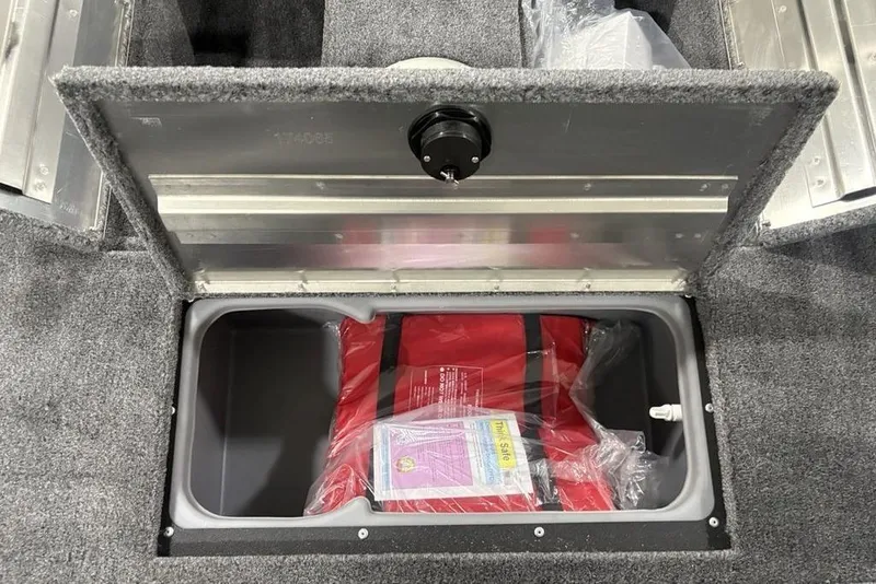 Slide: The Image of Storage compartment in 2026 Tracker Super Guide™ V-16 SC boat with life jacket inside. - 14