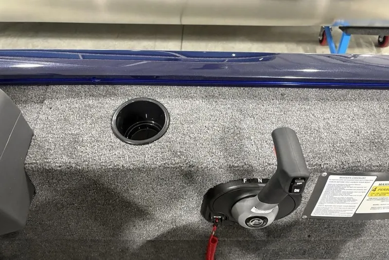 Slide: The Image of 2026 Tracker Super Guide™ V-16 SC boat interior with control lever and cup holder. - 17