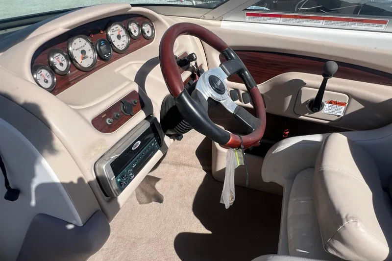 Slide: The Image of 2001 MasterCraft MariStar 230 VRS boat dashboard with gauges and steering wheel. - 10