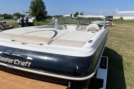 Slide: The Image of 2001 MasterCraft MariStar 230 VRS boat on grass, showcasing sleek design and spacious seating. - 8