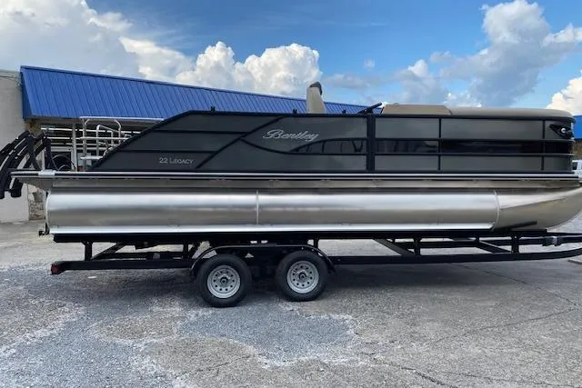 The Image of 2025 Bentley Pontoons Legacy 223 Swingback on trailer, sleek design, blue sky background. - 1