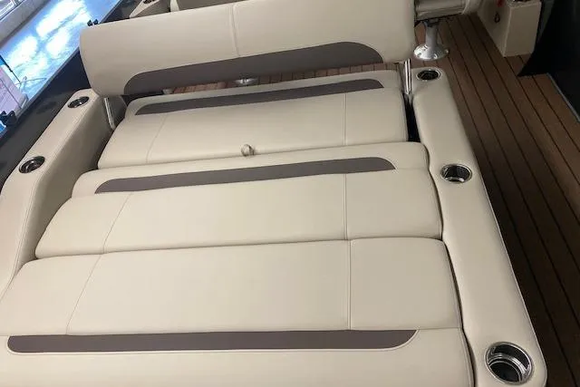 Slide: The Image of 2025 Bentley Pontoons Legacy 223 Swingback interior with beige seating and cup holders. - 6