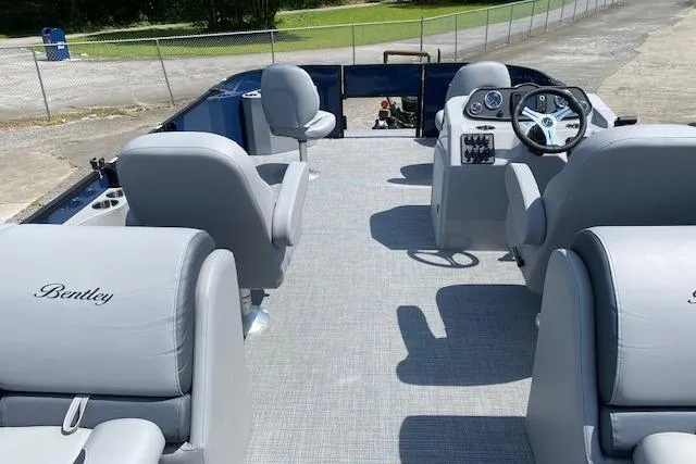 Slide: The Image of 2025 Bentley Pontoons Legacy 220 Fish Center Walk Thru with spacious seating and modern dashboard. - 3