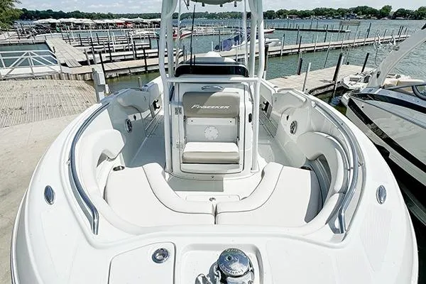 Slide: The Image of 2025 Crownline Finseeker 230CC boat docked, showcasing spacious seating and sleek design. - 4