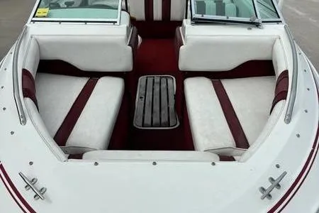 Slide: The Image of 1989 Sea Ray 160 Bow Rider interior with white and red seating, open bow design. - 3