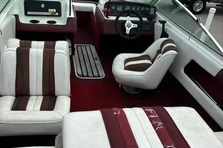 Slide: The Image of 1989 Sea Ray 160 Bow Rider interior with red and white seating and dashboard. - 4