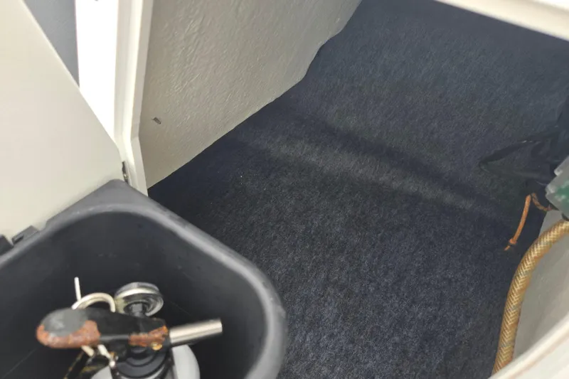 Slide: The Image of 2019 Yamaha AR195 boat interior storage compartment with keys and equipment. - 17