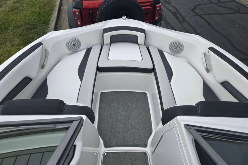 Slide: The Image of 2019 Yamaha Boats AR195 interior with cushioned seating and speakers. - 18