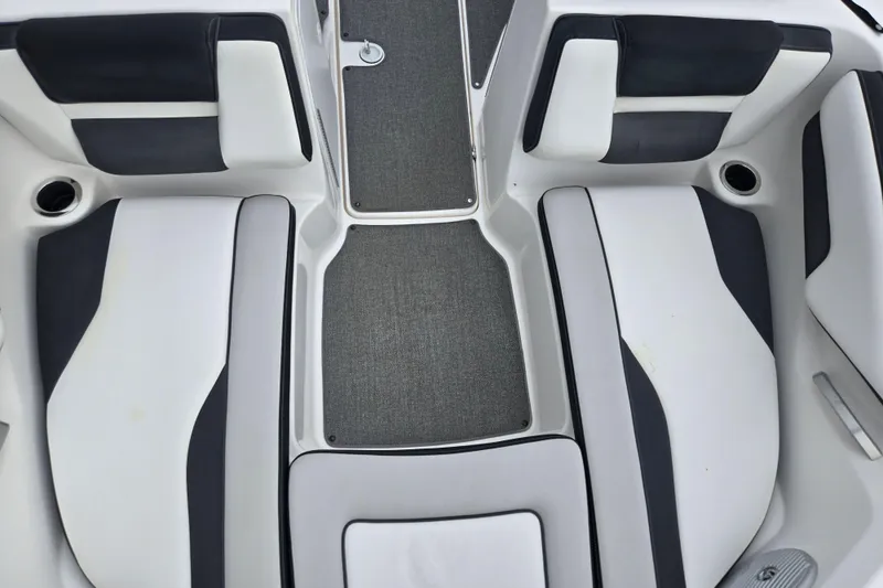 Slide: The Image of 2019 Yamaha Boats AR195 interior seating with gray and white upholstery. - 19