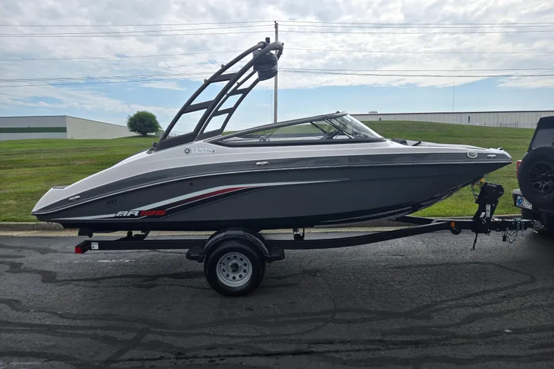 Slide: The Image of 2019 Yamaha Boats AR195 on trailer, sleek design, parked outdoors. - 4