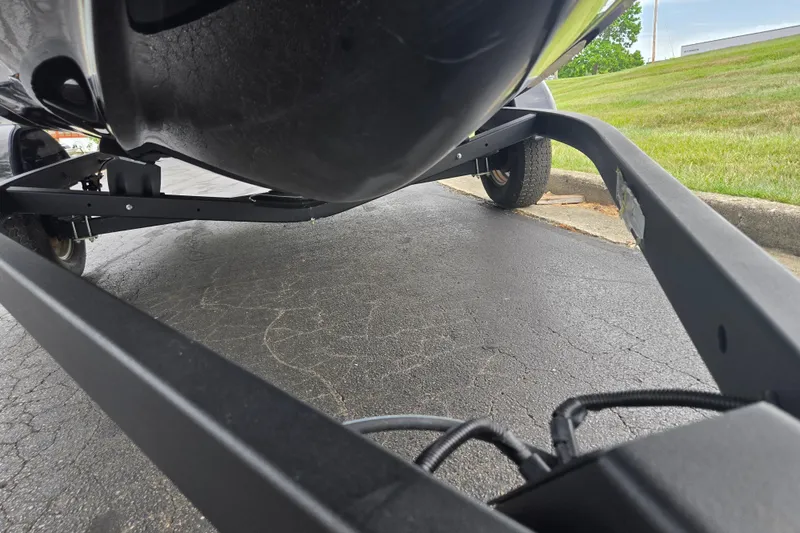 Slide: The Image of 2019 Yamaha Boats AR195 trailer view, showcasing undercarriage and wheels on pavement. - 7