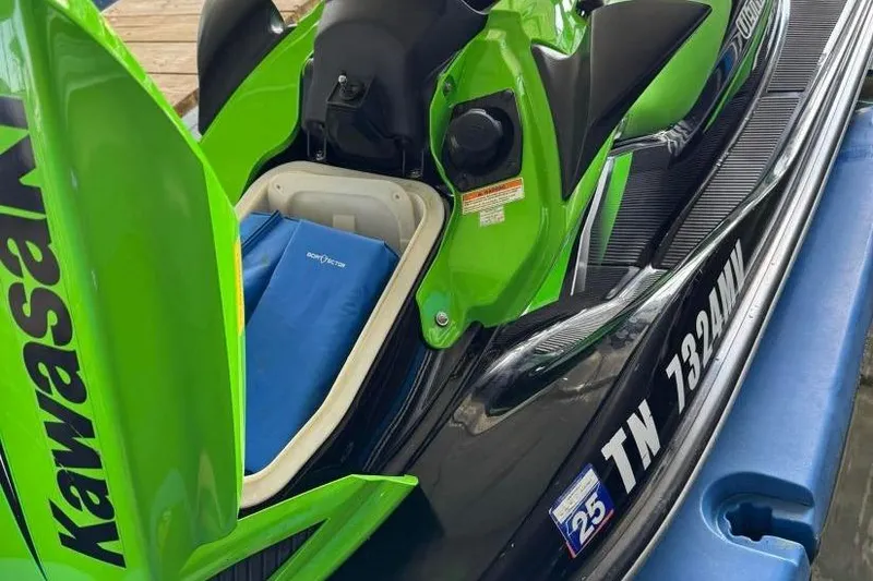 Slide: The Image of 2011 Kawasaki Ultra 300 X Jet Ski in green and black, open storage compartment. - 3