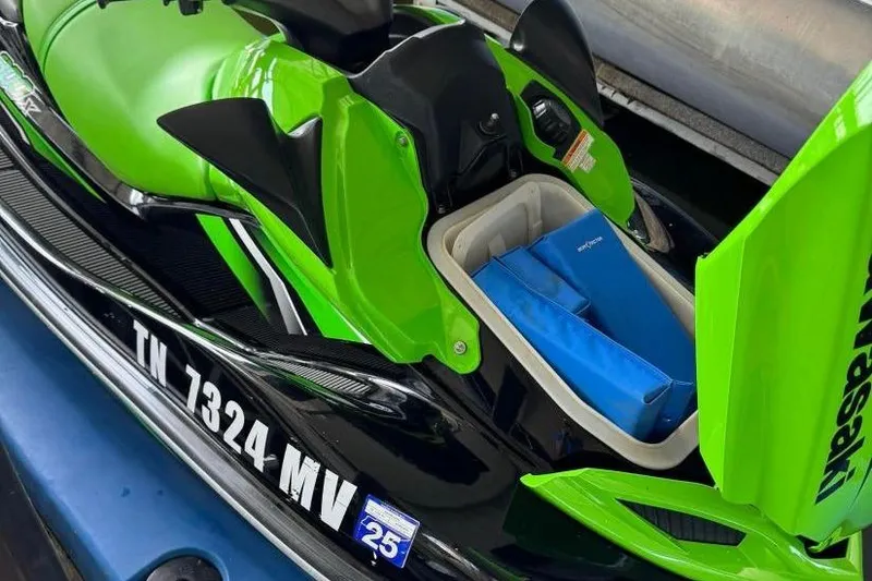 Slide: The Image of 2011 Kawasaki Ultra 300 X Jet Ski in vibrant green with storage compartment open. - 4