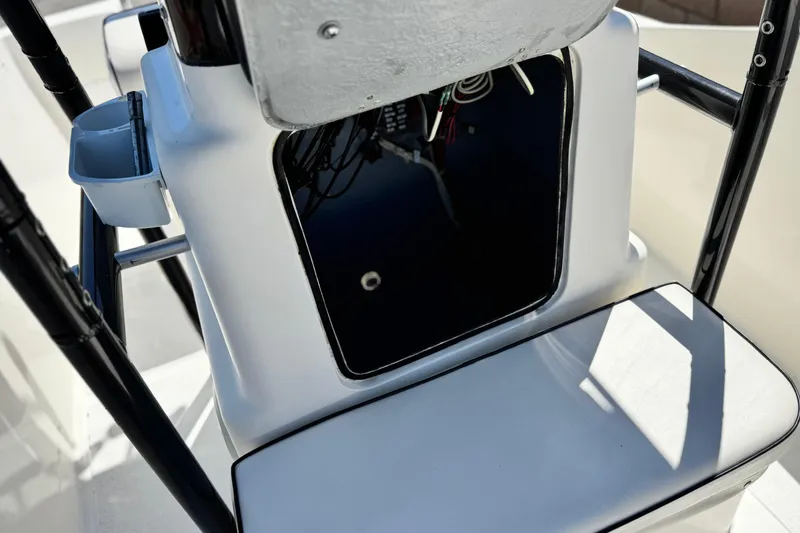 Slide: The Image of 2019 Thresher 19 CC boat console with open storage compartment and visible wiring. - 11