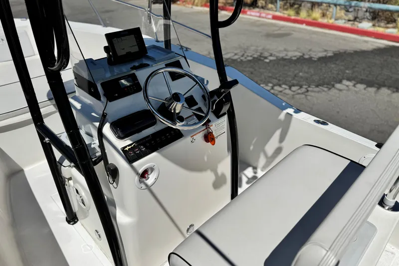 Slide: The Image of 2019 Thresher 19 CC boat interior with steering wheel and control panel. - 20