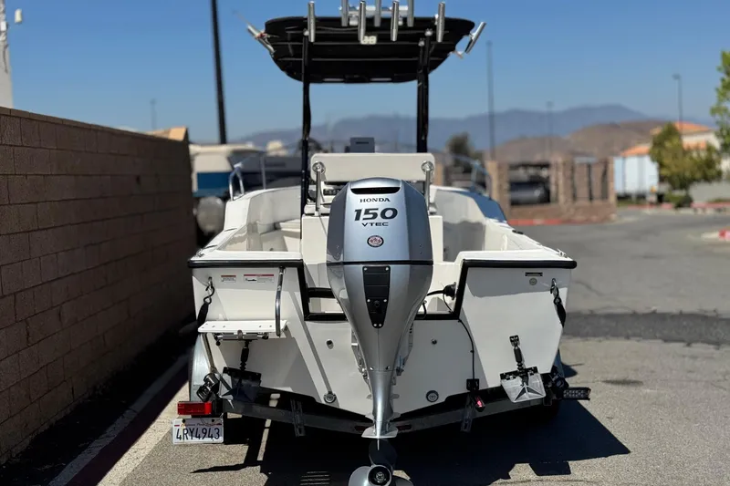 Slide: The Image of 2019 Thresher 19 CC boat with Honda 150 VTEC engine, parked outdoors. - 4