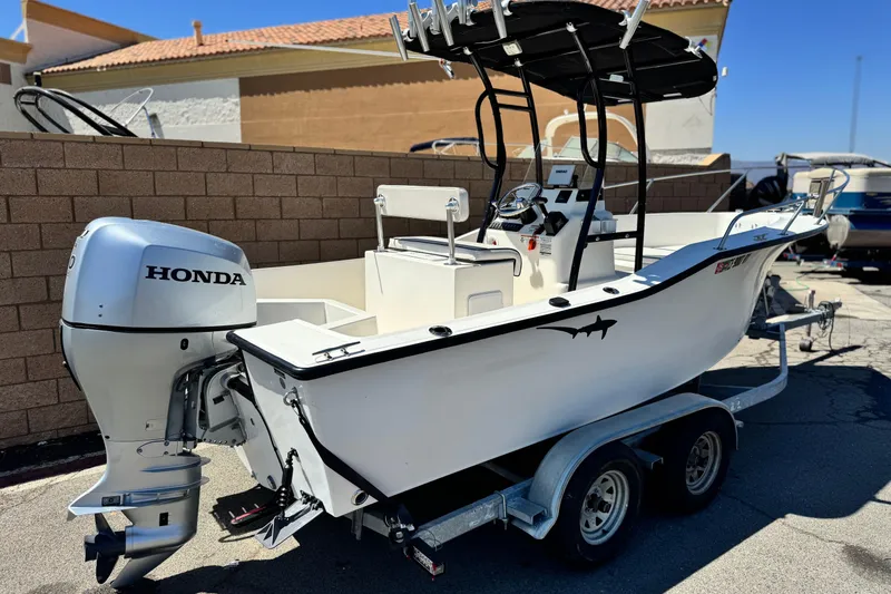 Slide: The Image of 2019 Thresher 19 CC boat with Honda outboard motor on a trailer. - 5