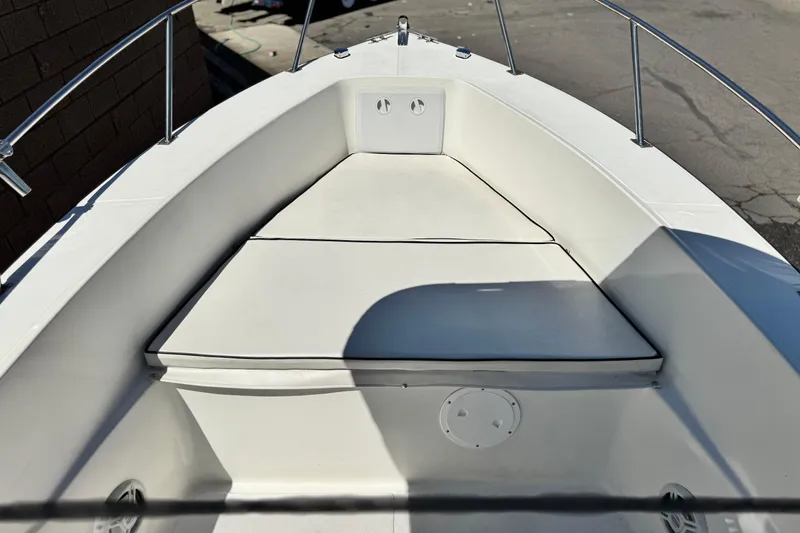 Slide: The Image of 2019 Thresher 19 CC boat interior with cushioned seating and stainless steel railings. - 8
