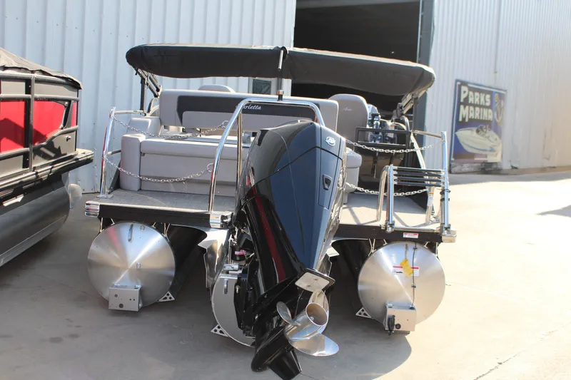 Slide: The Image of 2025 Barletta Aria 24UC pontoon boat with powerful outboard motor, docked at marina. - 3