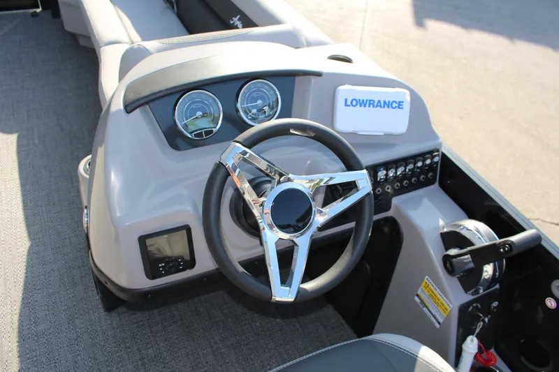 Slide: The Image of 2025 Barletta Aria 24UC boat dashboard with steering wheel and Lowrance navigation system. - 4