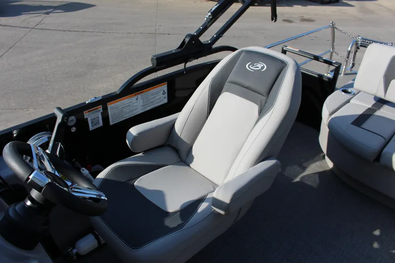 Slide: The Image of 2025 Barletta Aria 24UC boat interior with sleek captain's chair and steering wheel. - 6