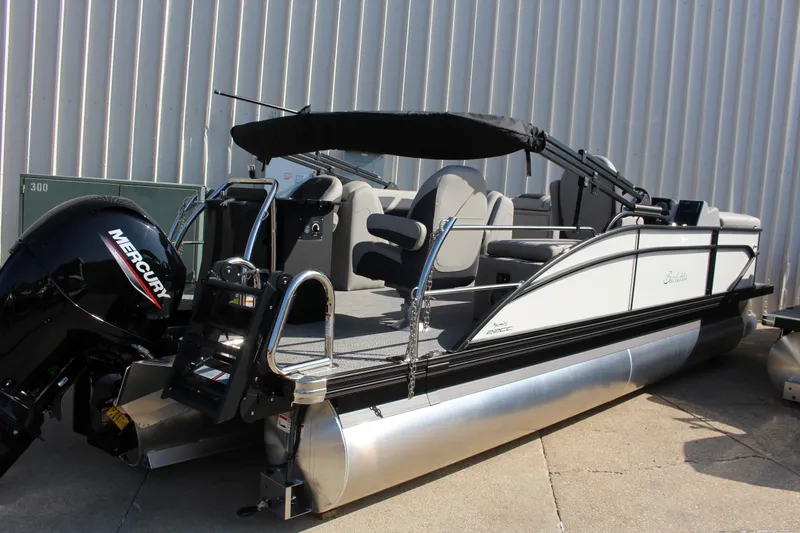 The Image of 2025 Barletta Cabrio 22CC pontoon boat with Mercury engine, docked outdoors. - 0