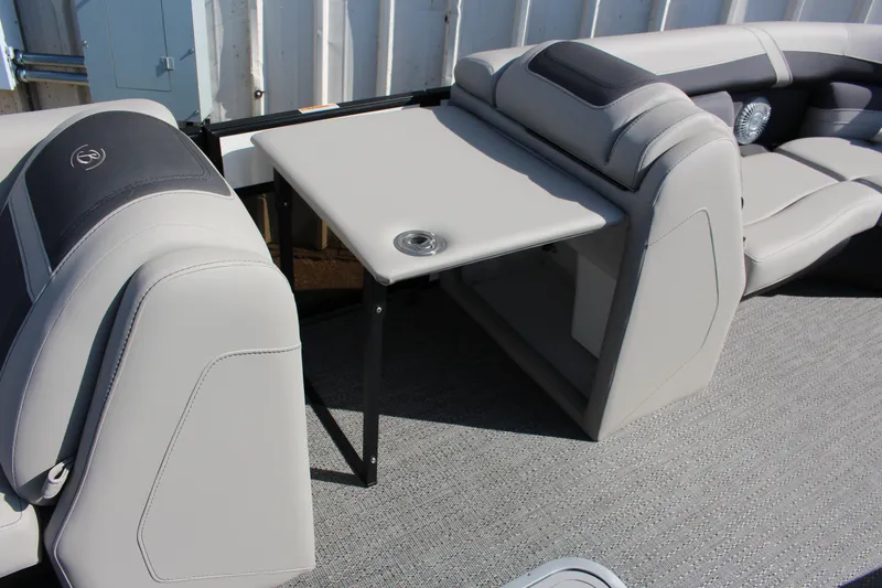Slide: The Image of 2025 Barletta Cabrio 22CC boat interior with gray seating and foldable table. - 10