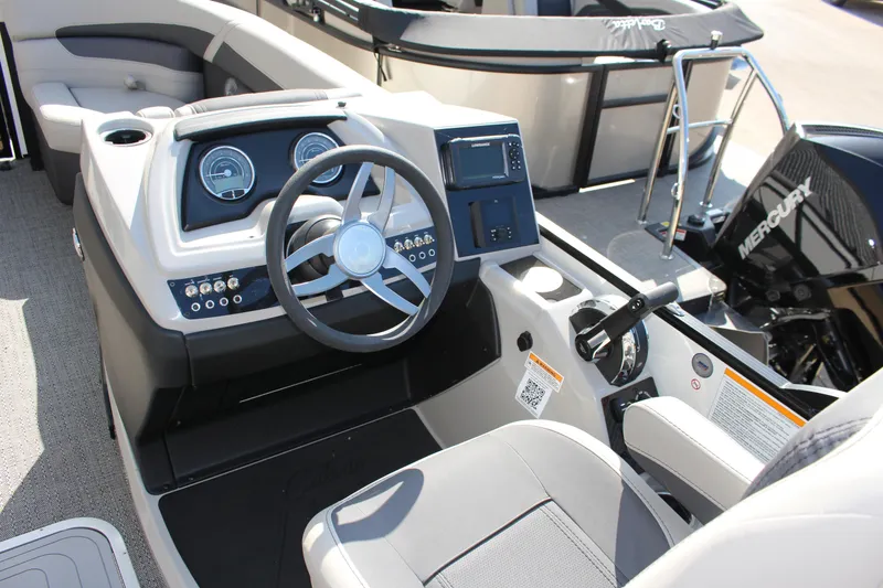 Slide: The Image of 2025 Barletta Cabrio 22CC boat dashboard with steering wheel and control panel. - 5