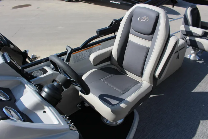 Slide: The Image of 2025 Barletta Cabrio 22CC boat interior with steering wheel and comfortable seating. - 6