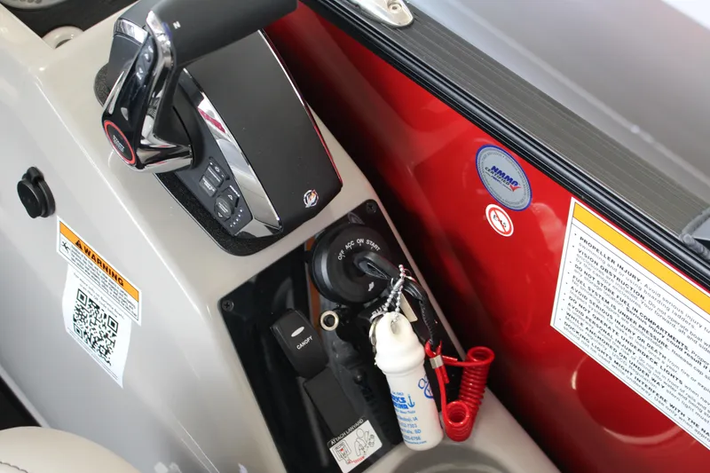 Slide: The Image of Control panel of 2025 Barletta Cabrio 24UE boat with safety warnings and ignition switch. - 10