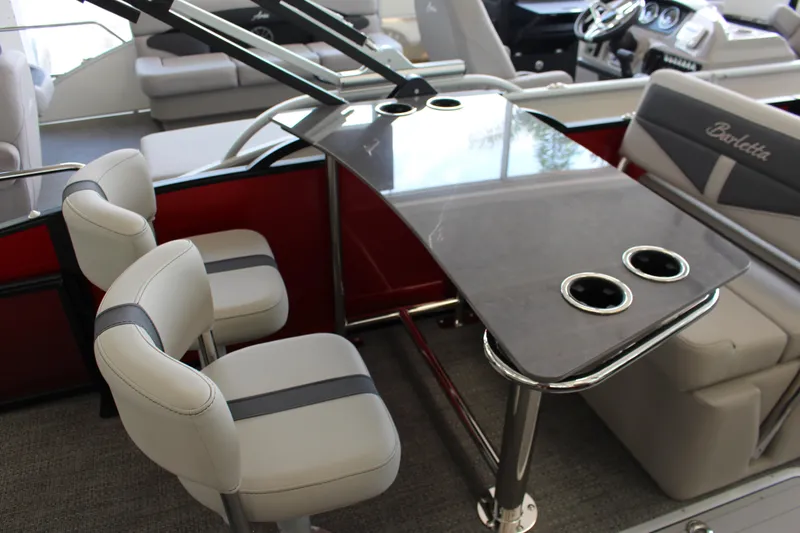 Slide: The Image of 2025 Barletta Cabrio 24UE interior with sleek seating and modern table design. - 12