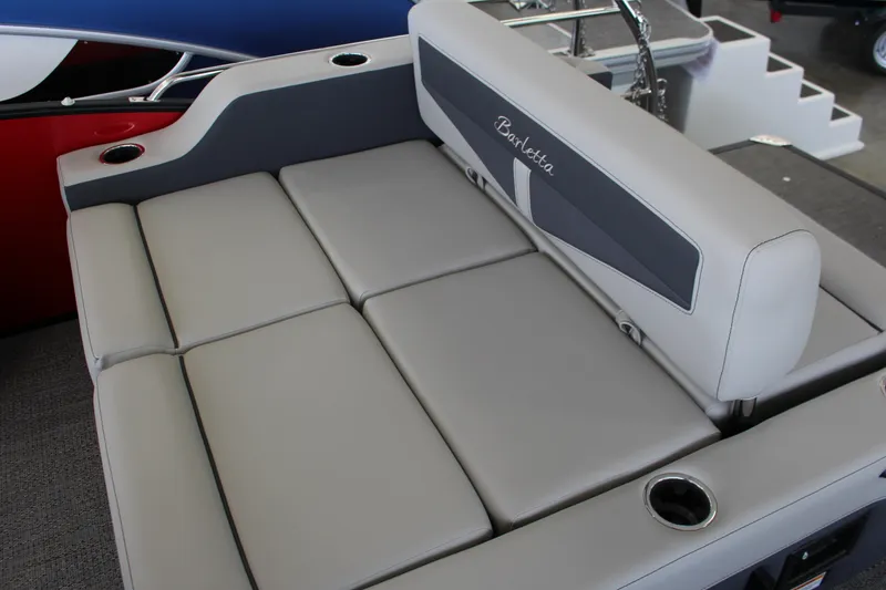 Slide: The Image of 2025 Barletta Cabrio 24UE boat interior with gray cushioned seating and cup holders. - 13