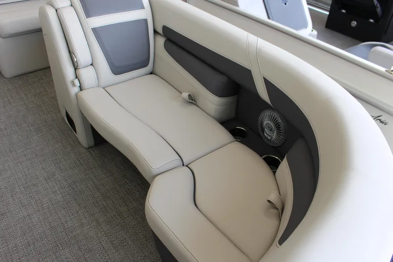 Slide: The Image of 2025 Barletta Cabrio 24UE boat interior with plush seating and cup holders. - 6