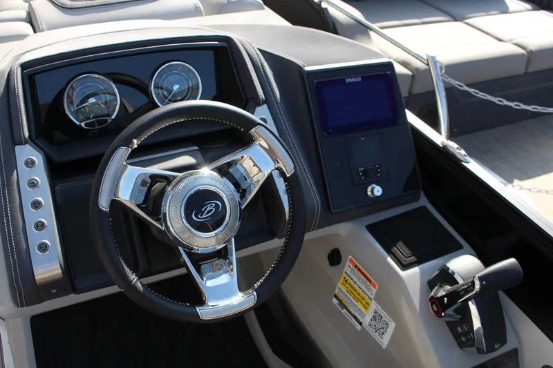 Slide: The Image of 2025 Barletta Lusso 23U boat dashboard with steering wheel and control panel. - 12
