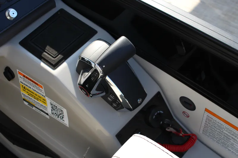 Slide: The Image of Control panel of 2025 Barletta Lusso 23U boat with throttle lever and safety features. - 13