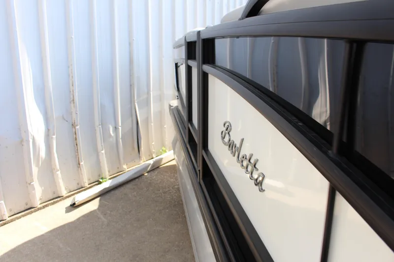 Slide: The Image of 2025 Barletta Lusso 23U pontoon boat side view with logo detail. - 5