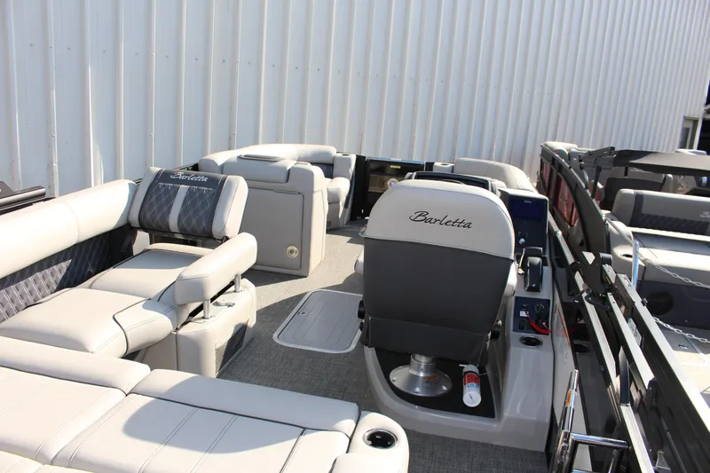 Slide: The Image of 2025 Barletta Lusso 23U pontoon boat interior with luxurious seating and helm. - 7