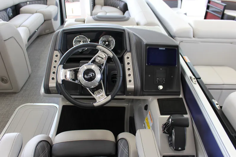 Slide: The Image of 2025 Barletta LUSSO 25U boat interior with modern steering and dashboard controls. - 11